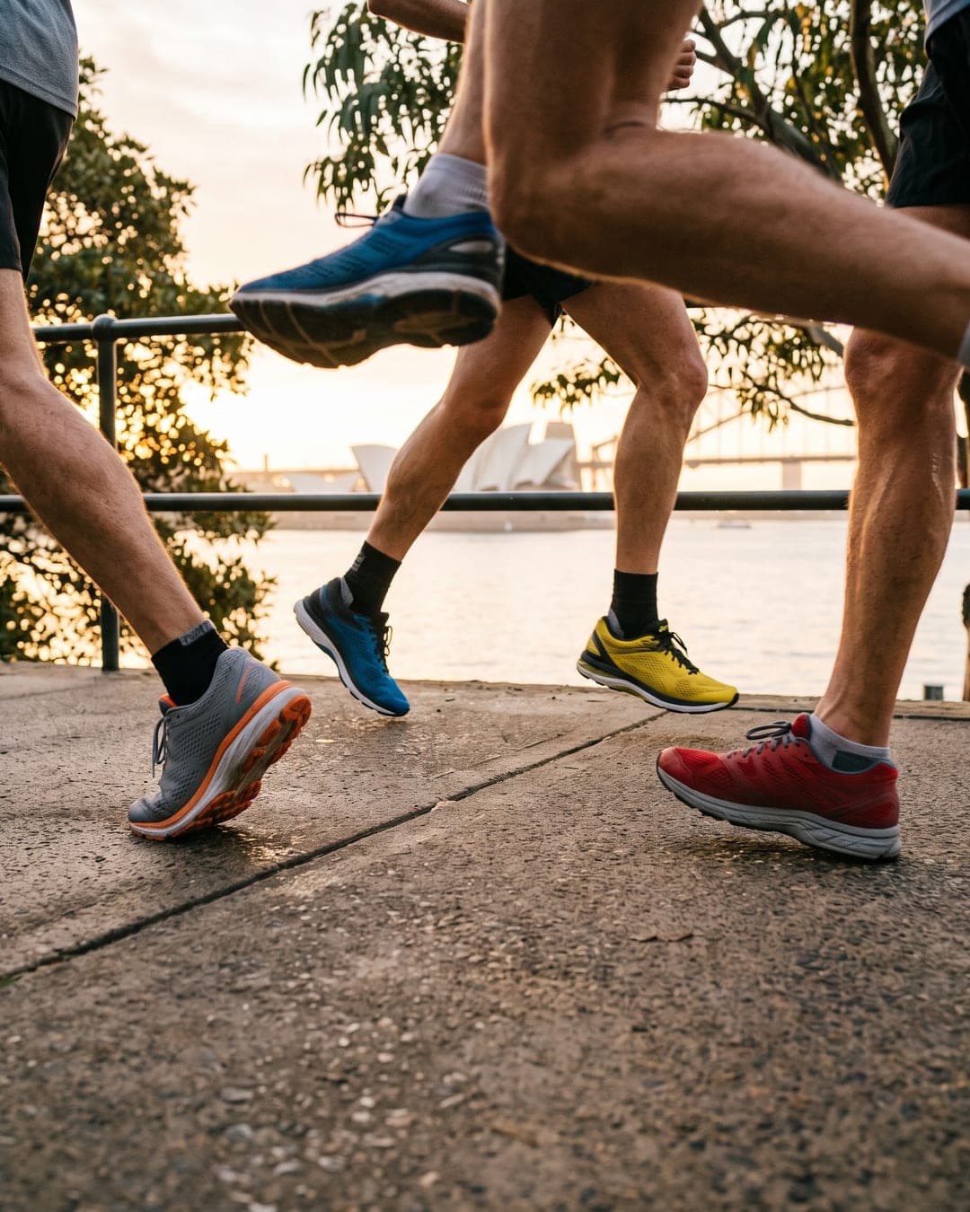 Running shoes on a harbourside path at sunrise